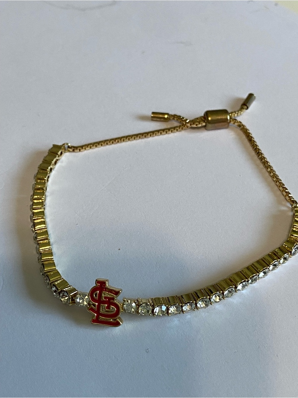 Gold-Tone Crystal Tennis Bracelet with St Louis Logo Charm Bauble Bar